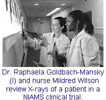 Photo: Dr. Raphaela Goldbach-Mansky and nurse Mildred Wilson review X-rays of a patient in a NIAMS clinical trial.