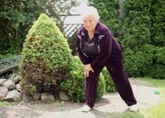 An older woman stretching her legs.