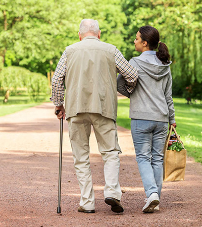 Older Man walking with a nurse
