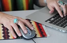 Woman's hand clicking a mouse button
